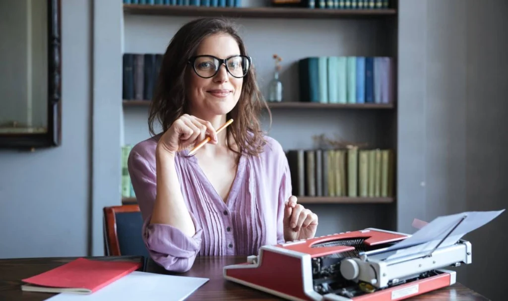 Female author using vintage typewriter