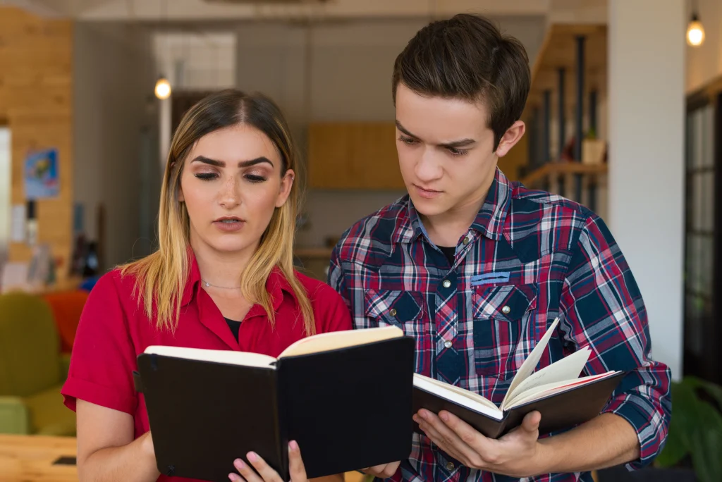 portrait-serious-boy-girl-reading-notes-notebooks